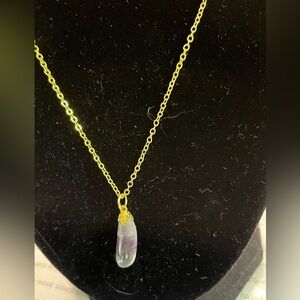 Amethyst colored stone with silver tone.